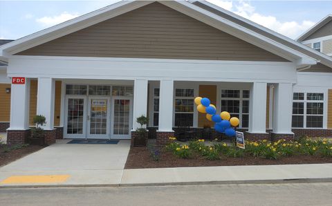 the outside of the clubhouse with balloons